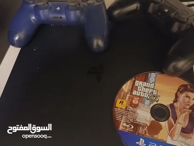 ps4 slim with 2 controllers and 1 gta 5 game one blue controller one black controller