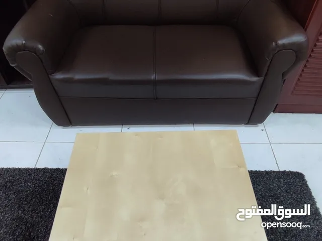 Two-seater leather sofa with wood table
