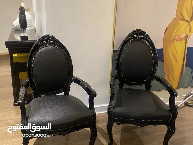 2 black arm chairs