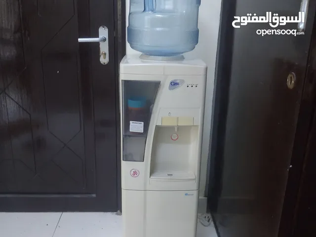 electric water cooler with 4 empty bottles