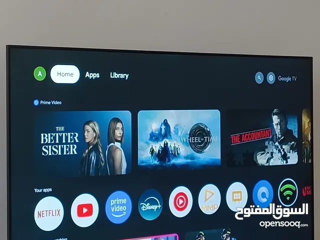 Phillips UHD 4K with remote and TV box.