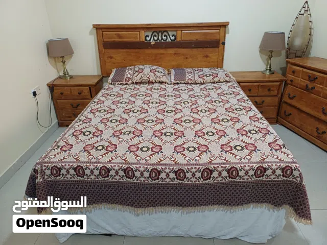 Queen size bed, dressing table and side tables.