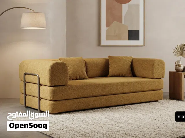Low-profile modular beige sofa bed with metal frame accents