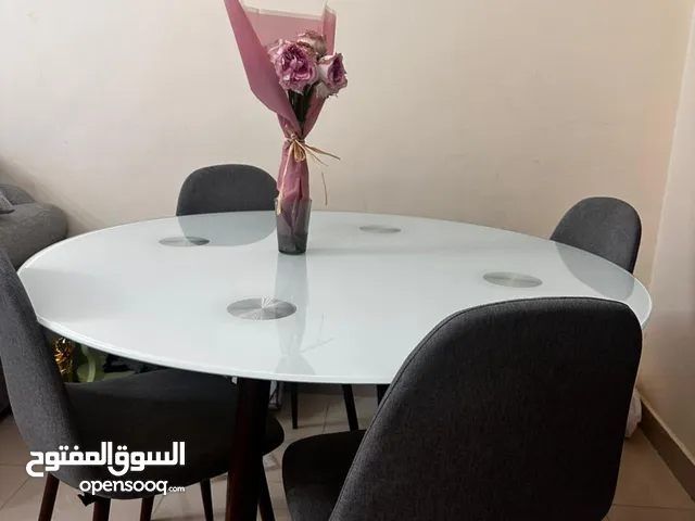 Round Glass Dining Table with Stylish Chairs