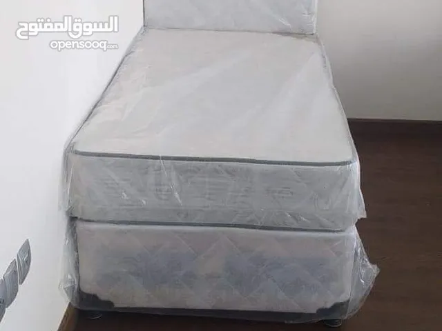 Single white color bed with mattress
