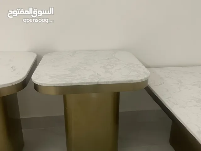 3 living room tables 2 side tables one main table, white marble and gold design.