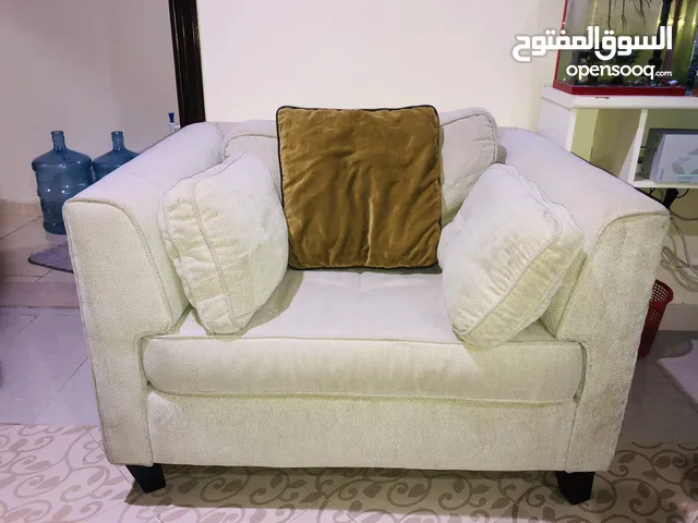 Two single seater sofa and glass table