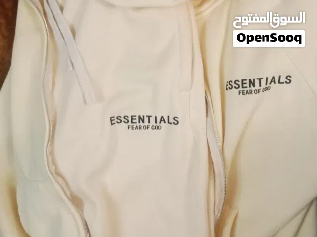 Based on the image provided, these are Fear of God Essentials cream/beige hoodies and a matching tra