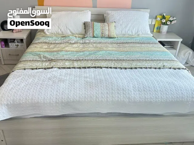 Full bed with two bedside tables and a mirrored dresser