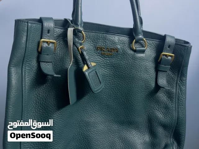 Prada Vitello Daino leather side-pocket tote bag in a teal or dark green color.