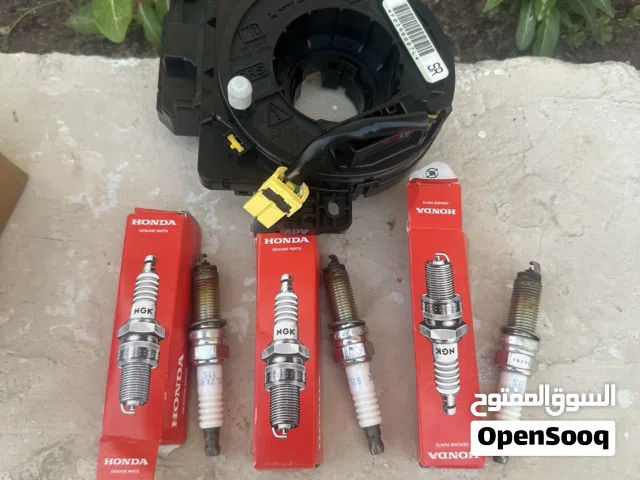 Three gone NGK spark plugs and a Honda City/Jazz Clock Spring
