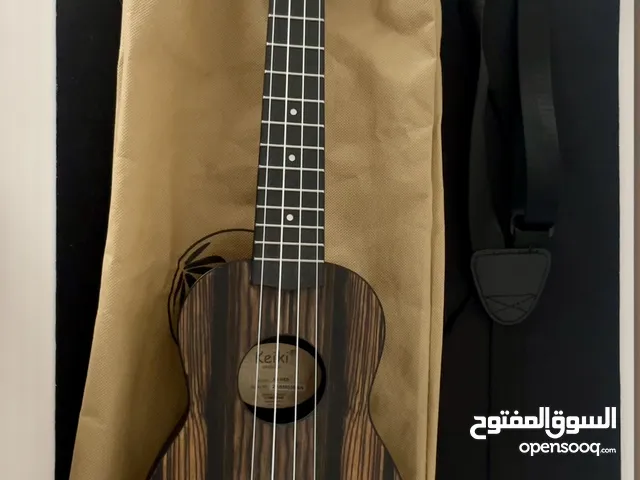 Ukulele with strap