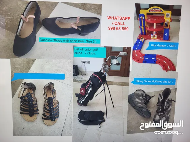 many items of kids clothing, shoes, games books for sale.