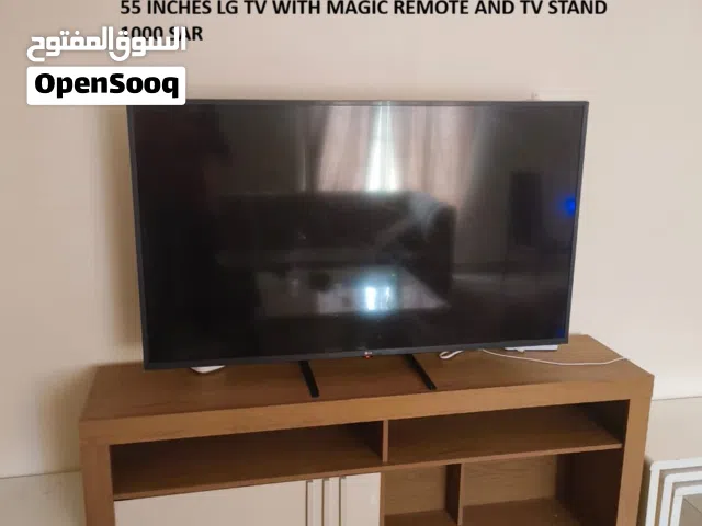LG 55" 4K Smart TV UHD AI ThinQ with magic remote. (Like new). TV stand is free