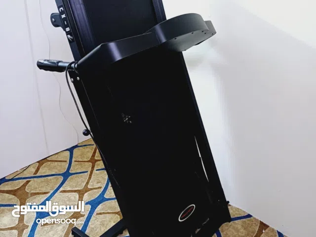 The image shows a black, foldable electric treadmill. It is designed for home use and can be folde