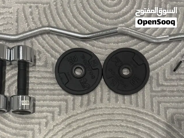 Home Weight Training Gym Setup. EZ Curl Barbell + 2x 5kg Dumbbells + 2x 2kg weight plates + 2 clips