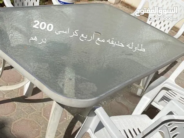 Outdoor glass table with 9 plastic chairs طاوله زجاج خارجيه مع 9 كراسي بلاستيك