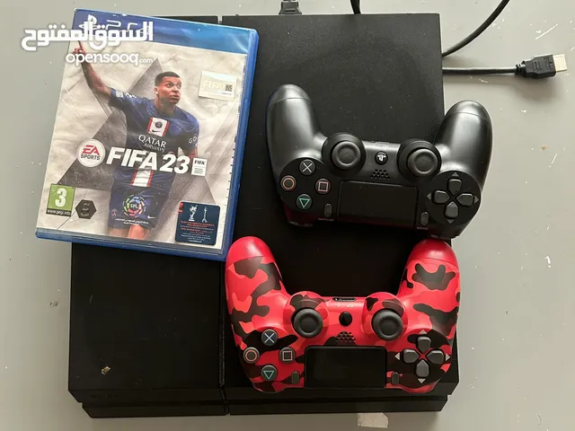 PS4 , a cd for FIFA 23 and 2 pads on it