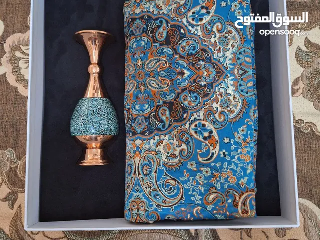An exquisite cashmere tablecloth paired with a turquoise candlestick.