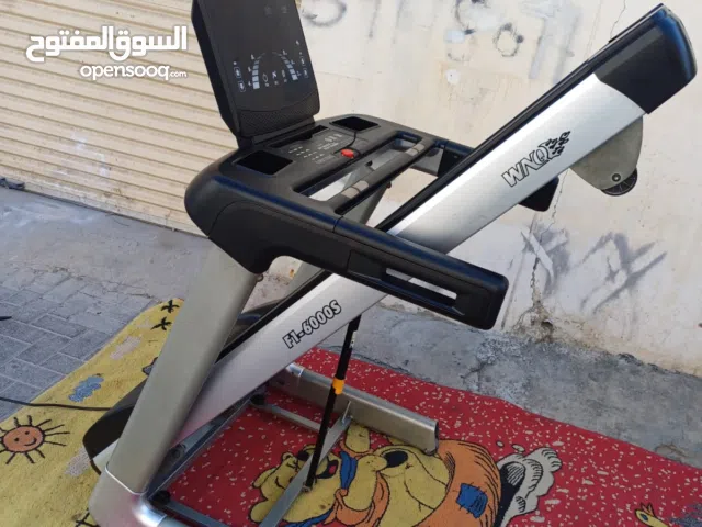 This is likely a WNQ F1-6000S commercial treadmill.   It is a motorized electric treadmill.  The tre