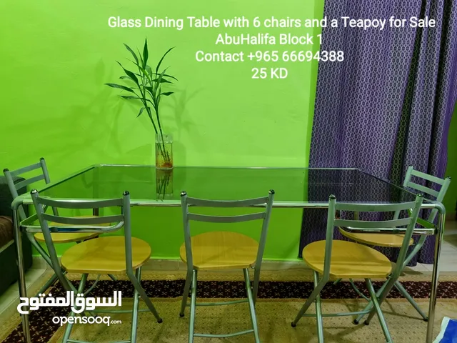 Glass Dining Table with 6 chairs and a teopoy