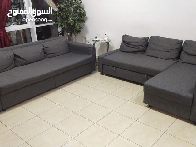 living room consists of two sofas: one L shape and other normal