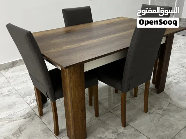 طاولة أكل شبه جديدة لوح متين ولون خشبي جميل ويمشي مع كل شي معاها اربعه كراسي خبش لا لونهم رصاصي