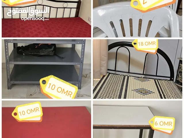 KING-SIZE BED COT/ SINGLE BED COT/ WHITE WOODEN TABLE/  PLASTIC TABLE/ PLASTIC CHAIRS/ IRON STAND