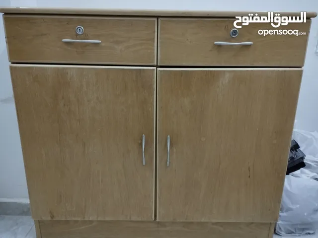 3 cupboards with a small table