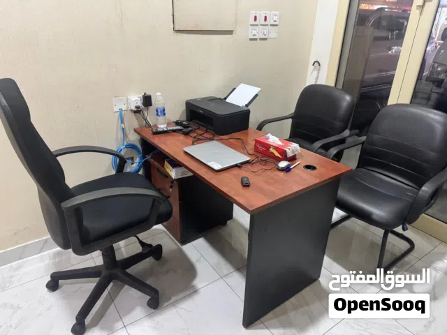 office desk and three chairs