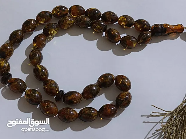 سبحة كهرب حجر لون ذهبي واسود