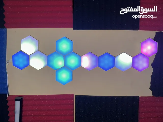 LED hex lights glow on a foam-treated wall, creating a stylish, sound-ready studio vibe.