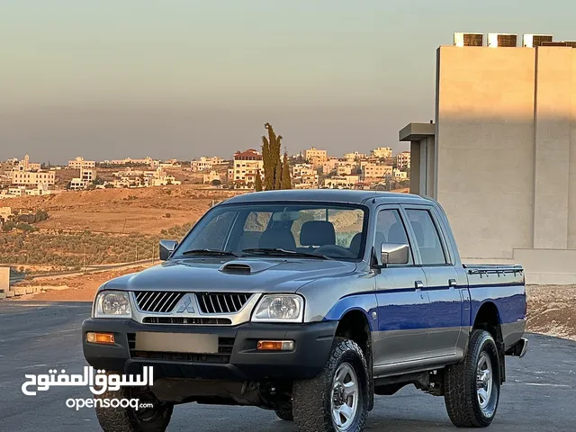 ميتسوبيشي L200 2005 لون سلفر مميزه فحص كامل قير عادي دفع رباعي 4x4