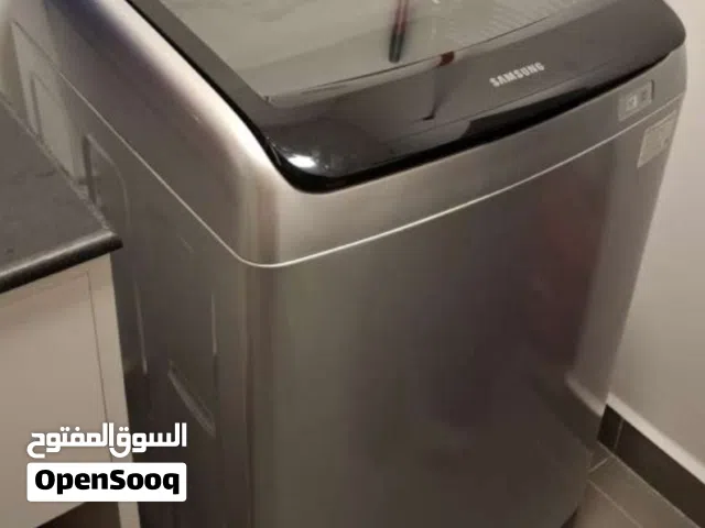 This is a Samsung top load washing machine featuring a dark gray, tempered glass lid 11kg
