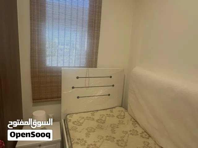 Single bed with mattress and side table