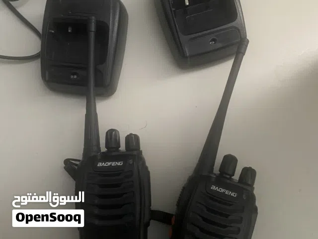 Pair of handheld Baofeng-style two-way radios with chargers