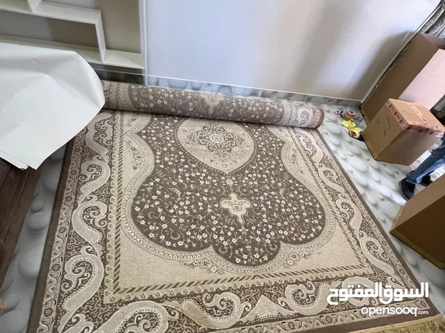 Heavily Used Brown-Based Multi-Colored Carpet