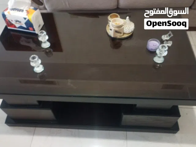 طاولة وسط مع اتنين جانبية خشب عليها وجه قزاز