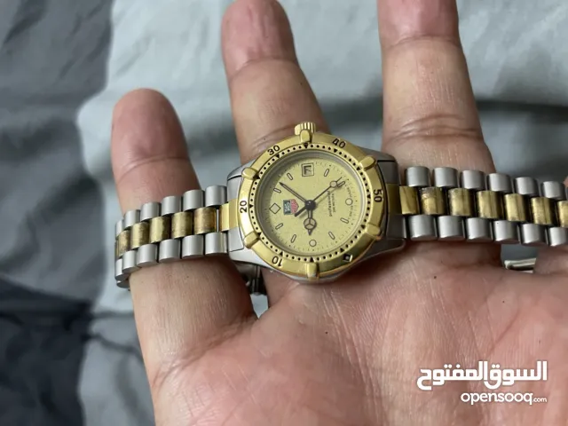 TAG Heuer 2000 Series Professional 200M quartz watch with a gold dial and a two-tone stain