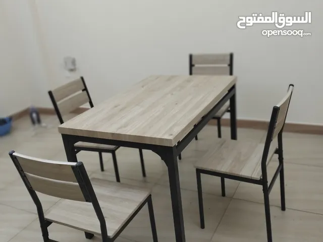 Wooden dining table with 4 chairs.