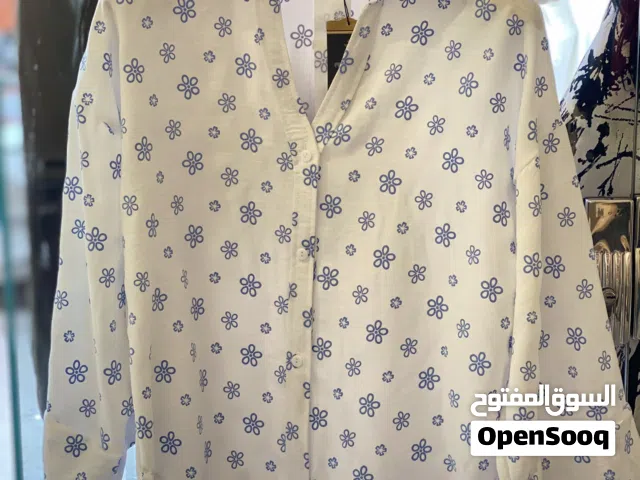 بلوزة حريمي شيك أبيض برسومات ورد أزرق – خامة مريحة وأنيقه
