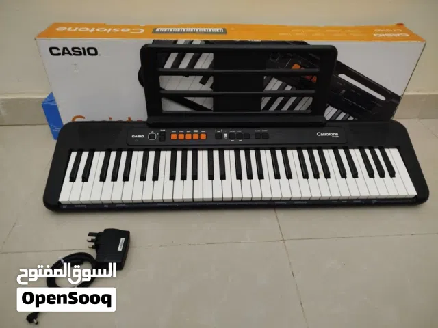 Casio piano with power adapter musical sheet stand and original box (like new)