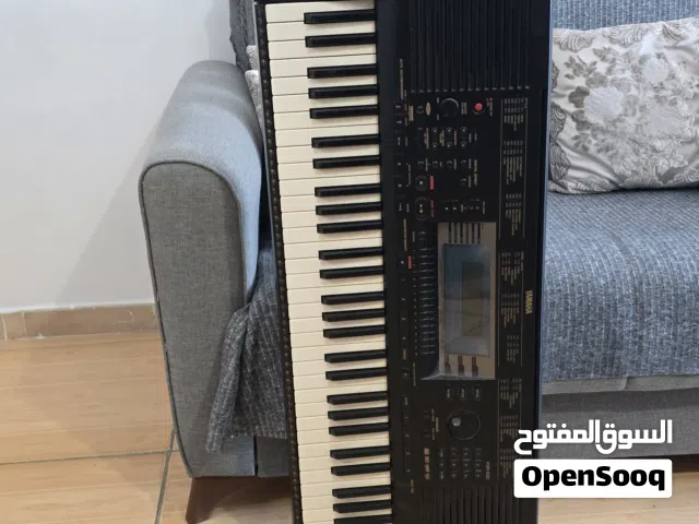 YAMAHA keyboard player with stand.