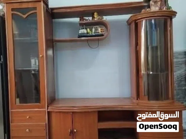 Elegent wooden wall unit with display cabinets and storage.