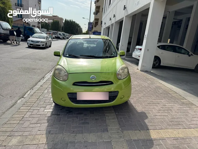 Green color Nissan Micra 2012