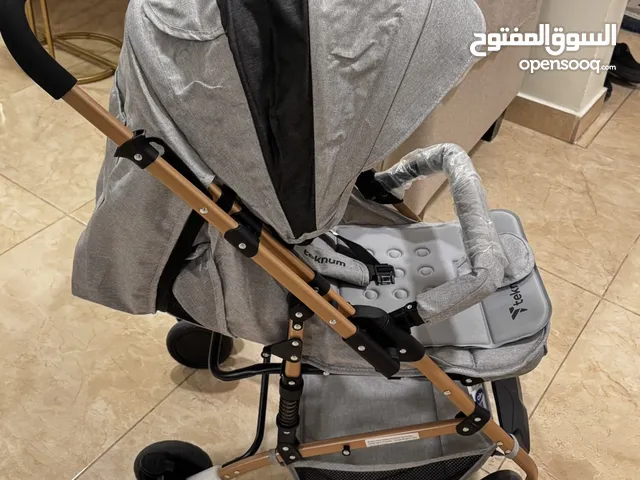 عربةأطفال ماركة تيكنوم - شبه جديده