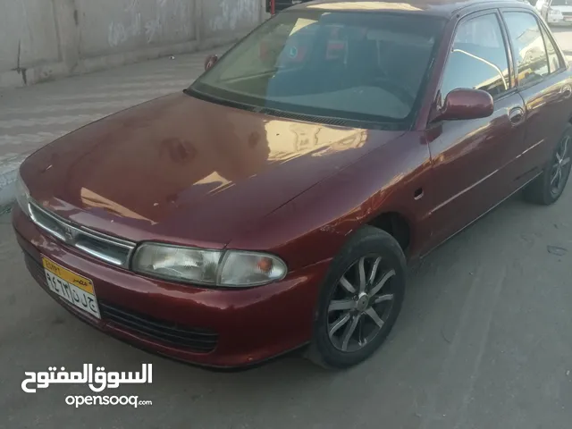 متسوبيشي لانسر بطه لون احمر ميتالك سياره مش محتاجه مصاريف لسه طلعه من شده