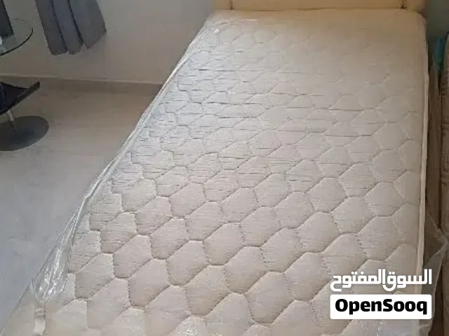 single bed and cot with a side table