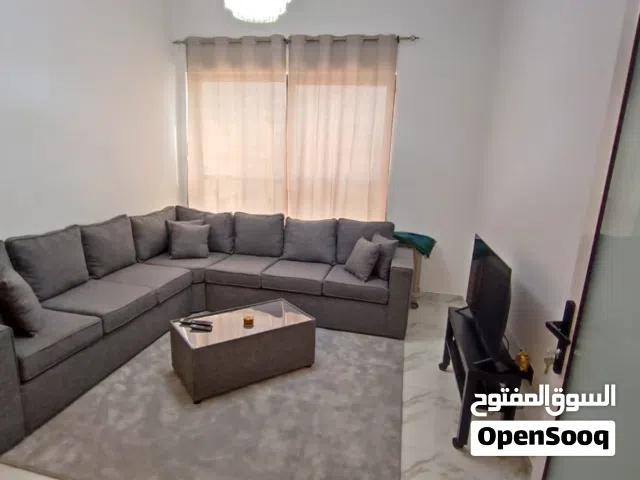 Elegant set including a comfortable grey sofa and a matching table,