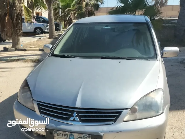 لانسر بومه 2014 للبيع فابريكه بالكامل لون ذهبي خليجي بمواصفات سعوديه مالك اول من الزيرو